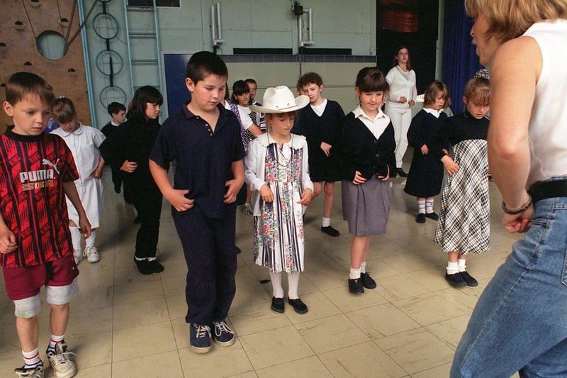 Armley Sports and Leisure Centre hosted a a line-dancing session for youngsters in July 1996. Pictured is Judy Pearson instructing the pupils from Ryecroft Primary.