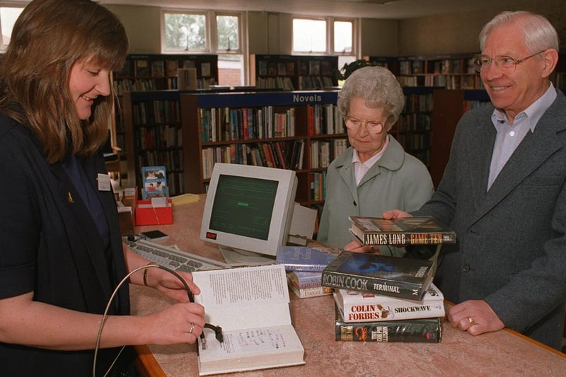 New computer systems were introduced at Garforth Library in June 1996. Pictured is chief librarian Jan Cryer with Mr and Mrs Smith.