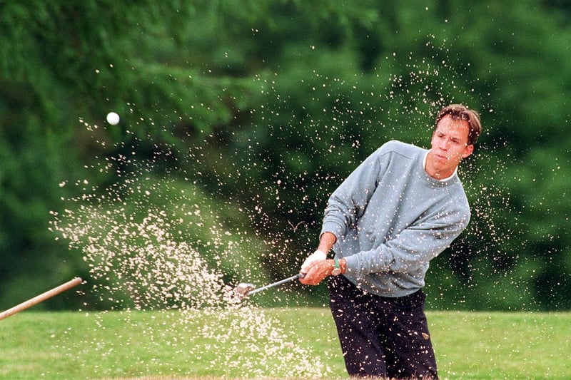 Damian McPherson of Garforth Golf Range plays out of a bunker in June 1996.