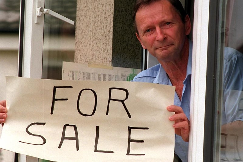 Frank Jones puts up the for sale sign at his bungalow at Cliff Top Park in July 1996.