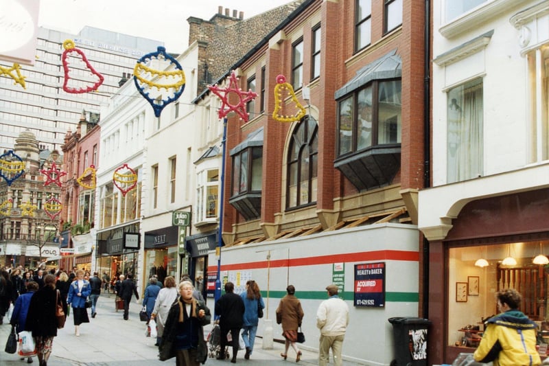 Commercial Street in November 1990.  The street is busy with shoppers and Christmas lights decorate the area.