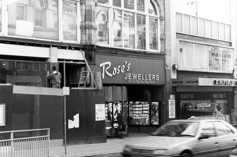 The east side of Briggate pictured in December 1990. Rose's jewellers is in view. On the right at the entrance to the Empire Arcade is P.B. newsagent and tobacconist.