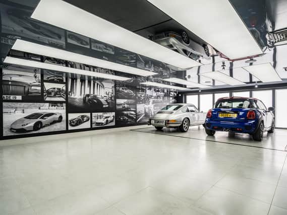 The owner has created a car gallery/showroom open plan to a sitting room so he can sit and enjoy his vehicles