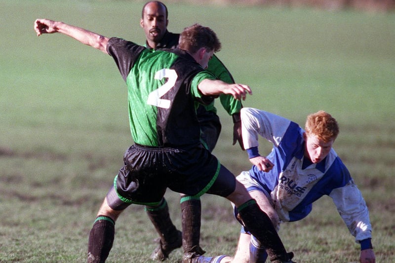 John Steenson of Horsforth Fairweather challenges Andrew O'Flaherty of Burley Cons during the Leeds and District Cup clash in January 1999.
