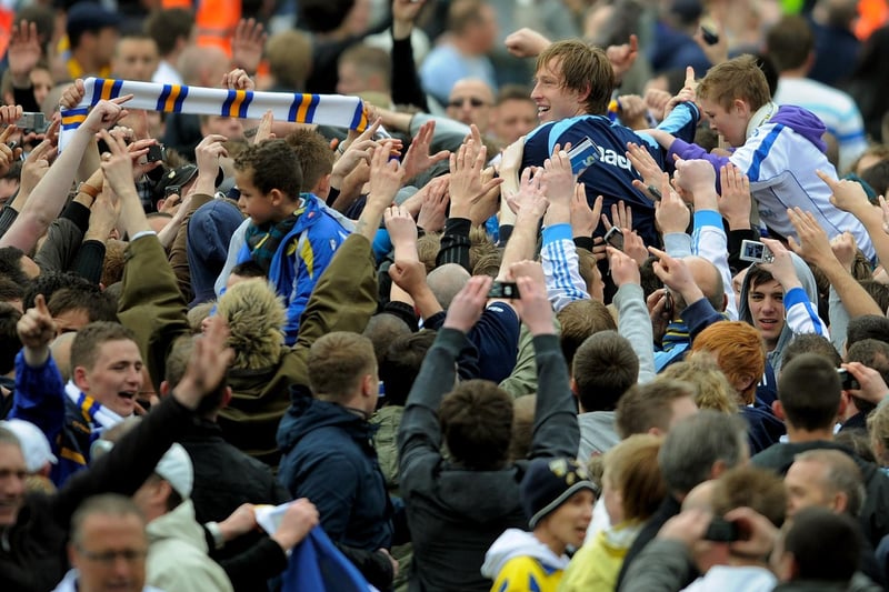 Striker Luciano Becchio is carried off the pitch by fans.