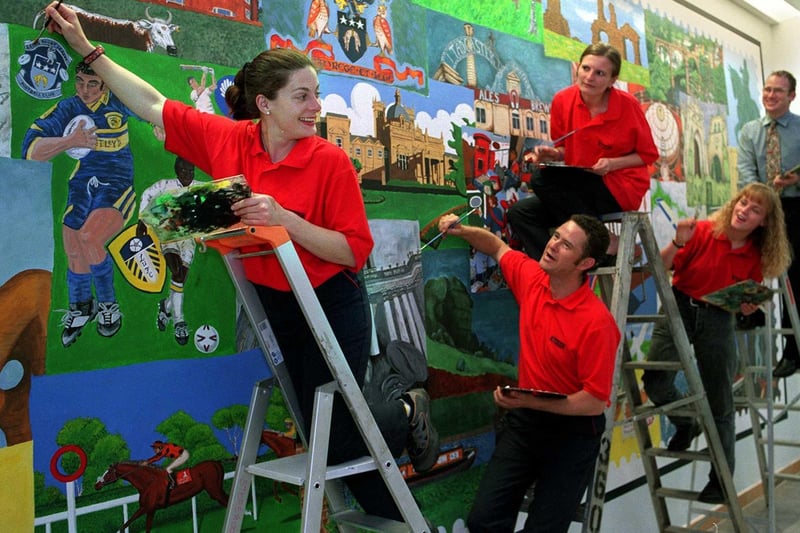 Staff at the Royal Mail Centre put the finishing touches to a giant mural they created in the reception area of their new base at Stourton. Pictured are Emma-Louise Greenwood, Sean Walsh, Kathryn Earl, Charlotte Green and Phil Robertson.