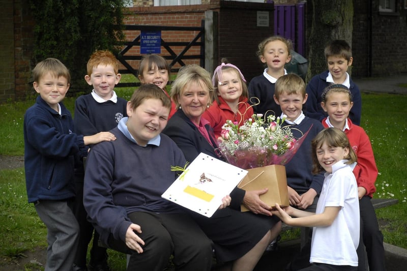Sherburn Primary School children celebrate receiving a good OFSTED report by making a presentation of flowers to their headteacher Carol Barnes.