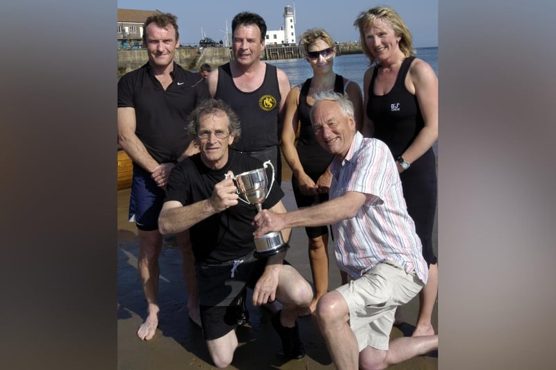 Freddie Drabble presents the rowing club’s Sid Smith Memorial Trophy.