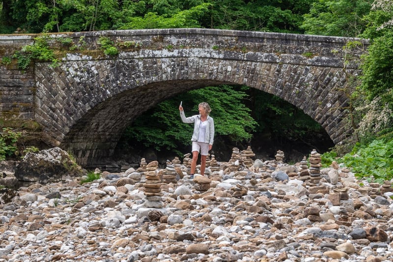 Many people have been exploring the riverbed since the water has gone underground, with some creating towers out of stones.