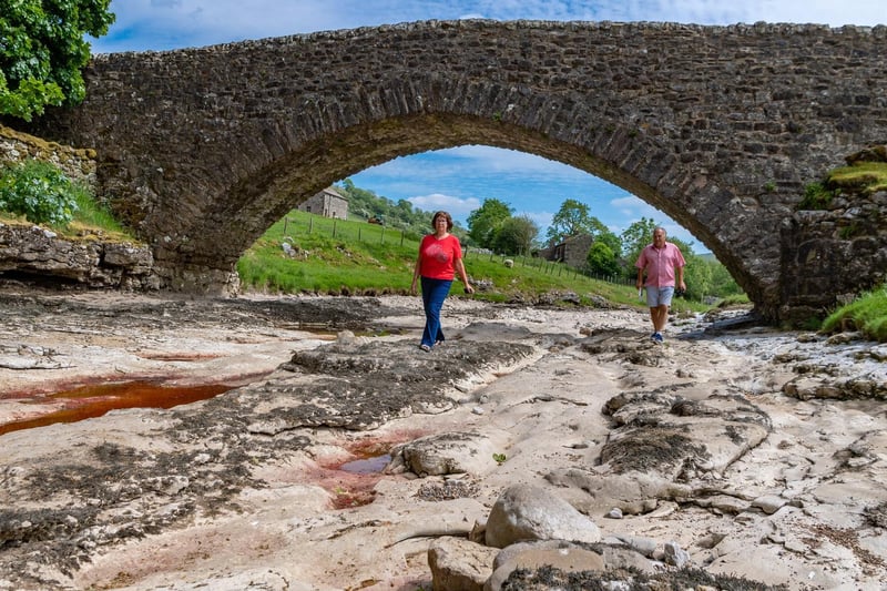 Robin and Karran, Eames, (correct) of Halifax, exploring the dry riverbed of the River Wharfe close to Top House Farm, Yockenthwaite, North Yorkshire.