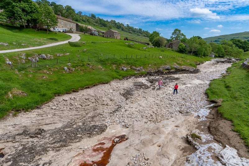 Robin and Karran, Eames, of Halifax, exploring the dry riverbed of the River Wharfe close to Top House Farm, Yockenthwaite, North Yorkshire