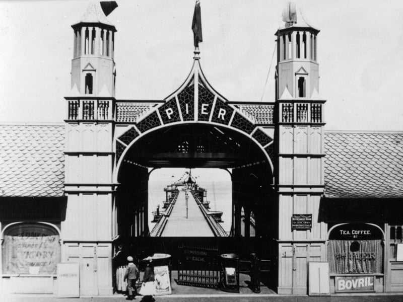 The length of North Bay Pier promenade walkway can be seen through the elaborate entrance to the structure. People were reportedly hesitant to walk out over the rough North sea.