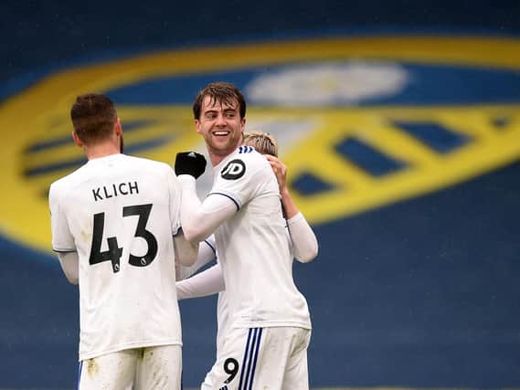 ALL SMILES: Whites striker Patrick Bamford, centre, celebrates his strike against Tottenham in the 3-1 victory at Elland Road in May. Photo by OLI SCARFF/POOL/AFP via Getty Images.