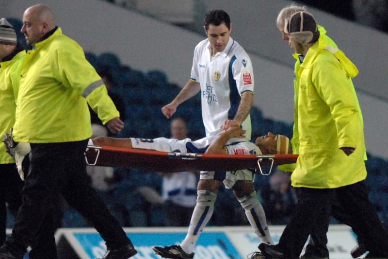 Andy Hughes talks to Patrick Kisnorbo after he was stretchered off during Leeds United's clash with Millwall at Elland Road in March 2010.