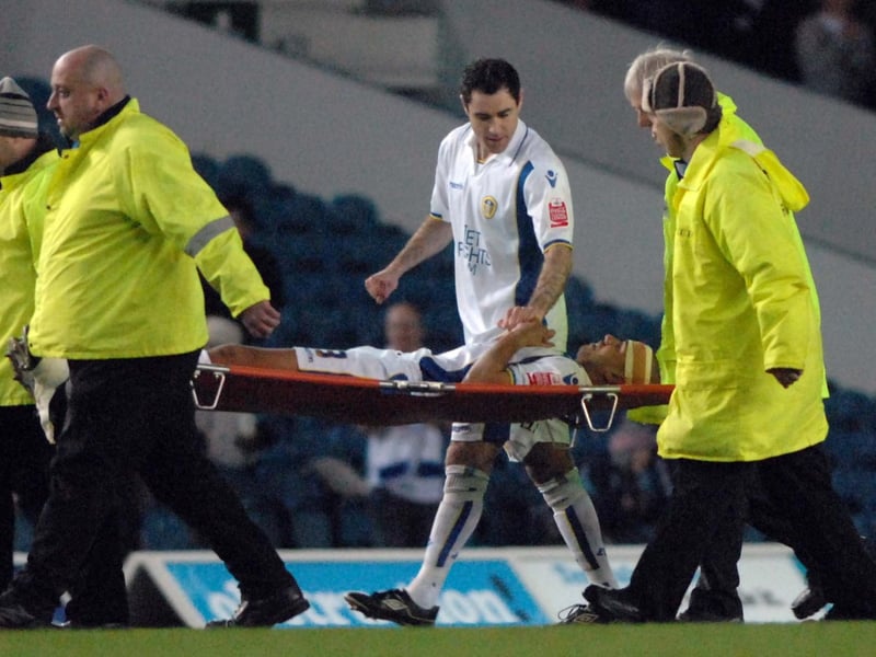Andy Hughes talks to Patrick Kisnorbo after he was stretchered off during Leeds United's clash with Millwall at Elland Road in March 2010.
