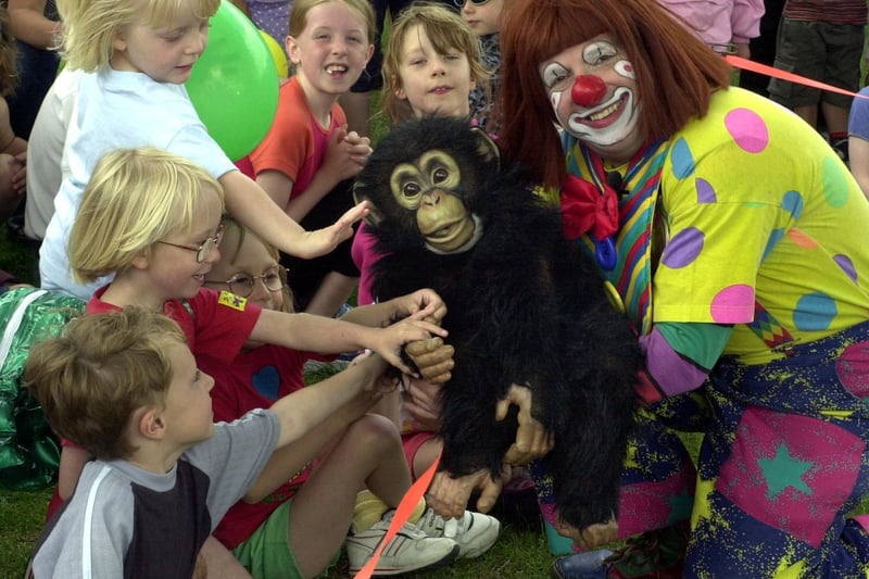 Truffles the clown entertains children with his puppet monkey 'Charlie' at Horsforth Hall Park in June 2001.
