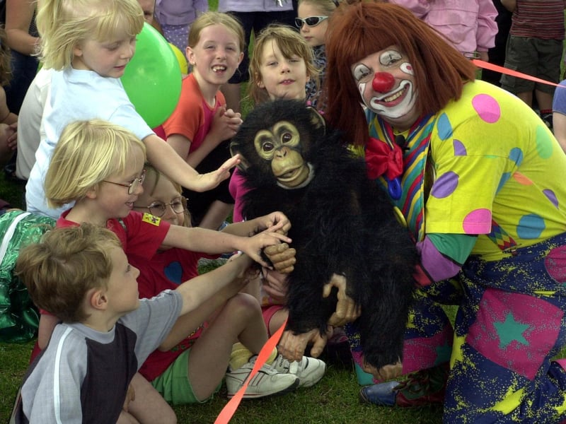 Truffles the clown entertains children with his puppet monkey 'Charlie' at Horsforth Hall Park in June 2001.