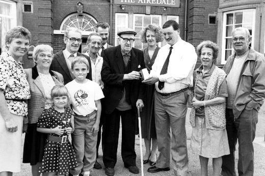 A press photograph of Bill Firth, aged 95, being awarded a tankard outside his local, The Airedale in Castleford