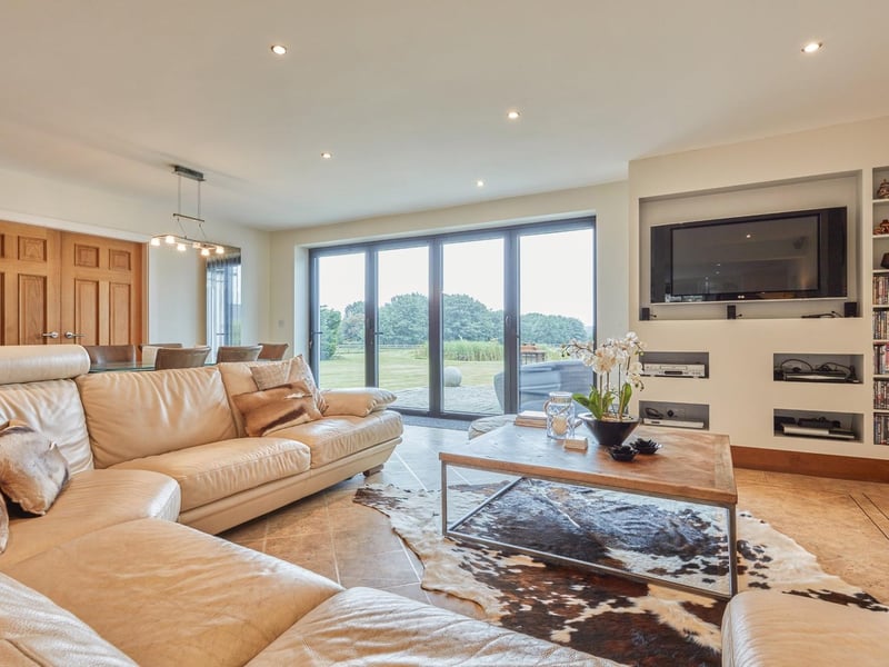 The TV room with views onto the garden via bi-fold doors