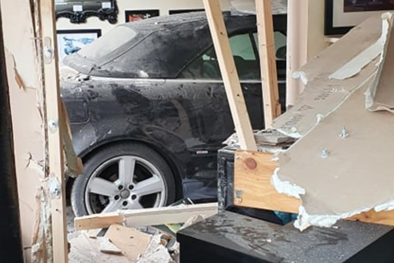 A Pudsey barber has been forced to close his shop temporarily after a car ploughed through the front of his building - destroying interior walls and bursting water pipes.