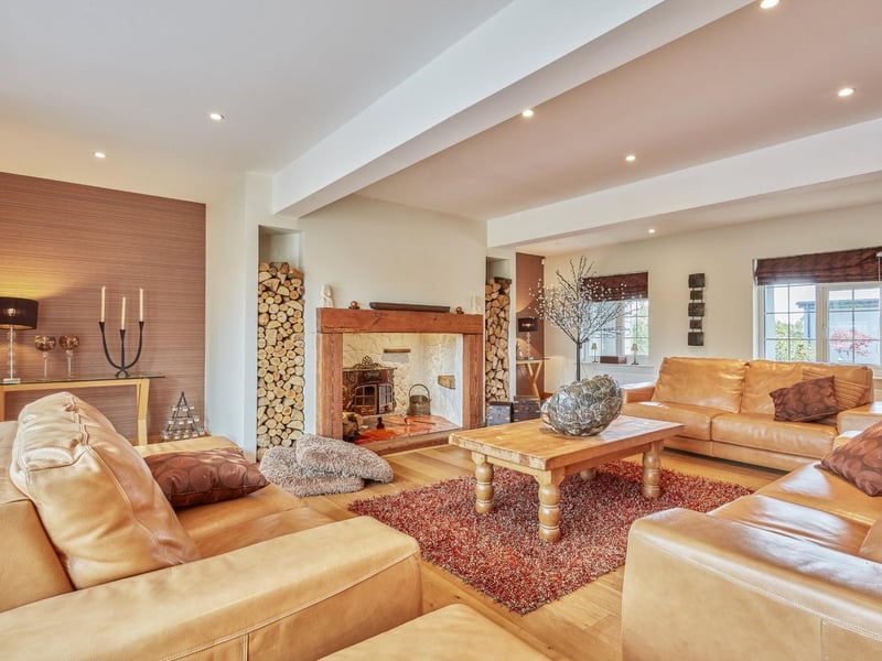 One of the sitting rooms on the ground floor with cosy wood-burning stove