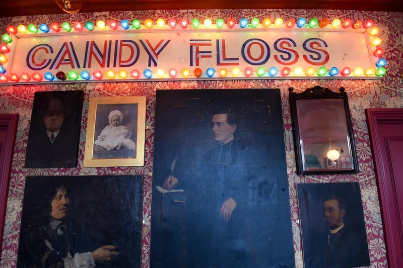 Wall art includes traditional resort "candy floss" signs illuminated by colourful bulbs, alongside old photographs. Picture copyright: Daniel Martino/JPI Media