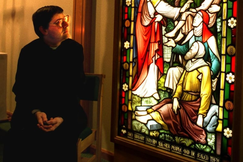 Chaplain Rev Peter Benson looks at a stained glass panel in the chapel at Dewsbury General Hospital in March 1996.