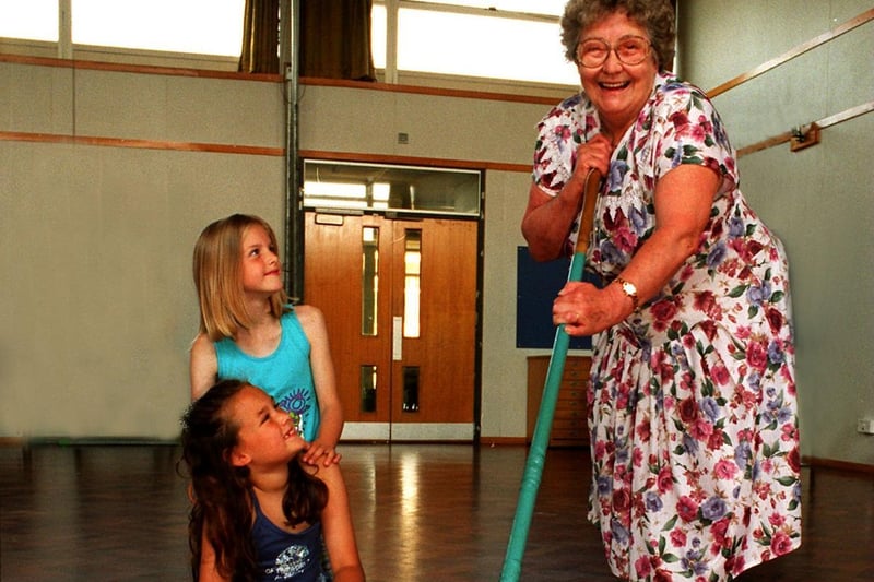 Sheila Buckingham was retiring after 34 years at Robberttown Junior and Infant School. She is pictured giving the school hall a last sweep, watched by pupils Emily Calvert (front) and Emily Armitage.