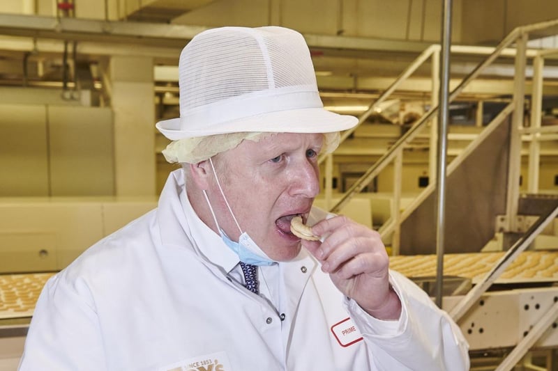 When tucking into one of the biscuits, the jam exploded all over Mr Johnson. 'Anyway, it was very good!' he said. Photo by Joel Anderson