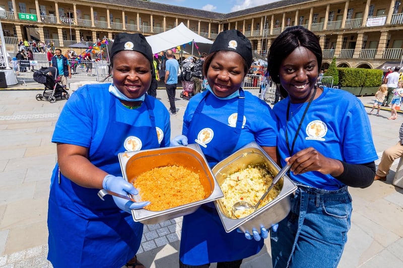 Fola Ifekoya, Amaka Akabuo, and Faith Nyamakanga from Light Up Black & African Heritage Calderdale, offering tasty food to t the visitors