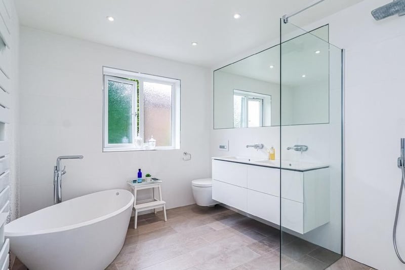 A house bathroom with bath and separate shower cubicle