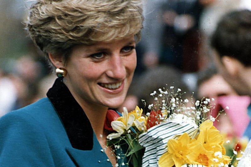 Diana, Princess of Wales, receives flowers from well wishers during a visit to the city in 1991.