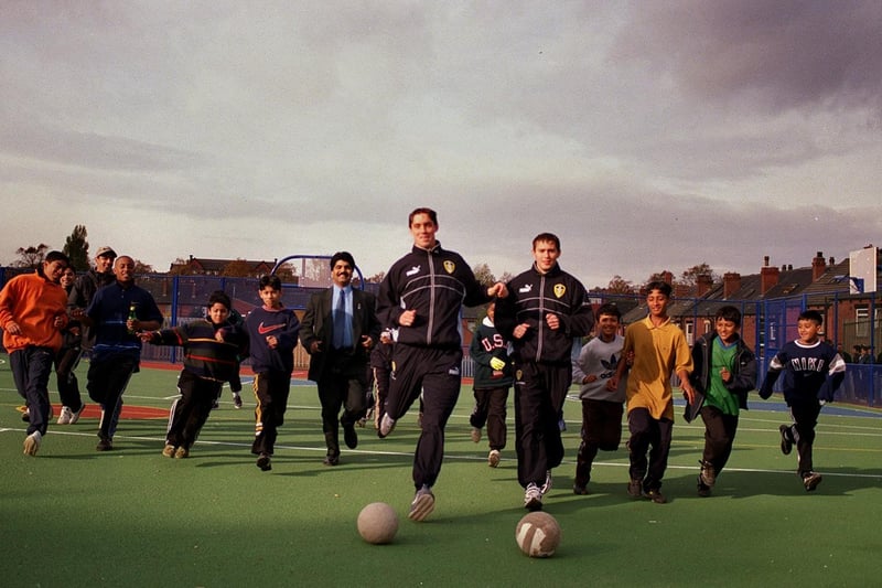 Leeds United footballers Kevin Evans (centre left) and Simon Watson together with Coun Mohammed Khan play football on a new multi-sports court at Bankside Primary.