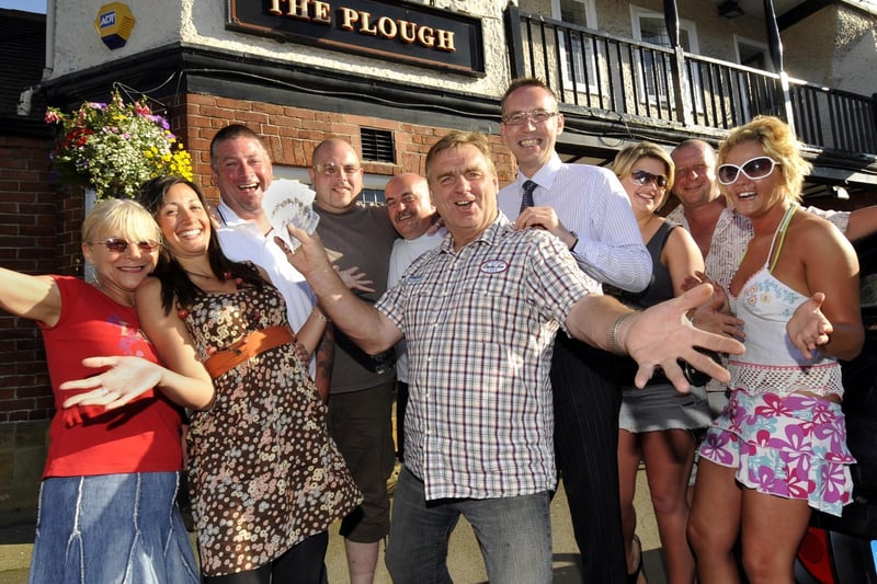 Clive Welburn, centre, Scalby’s Got Talent winner presents £200 to St Catherine’s Hospice director of  fundraising David Marshall, centre right, watched by his friends and fans at The Plough.