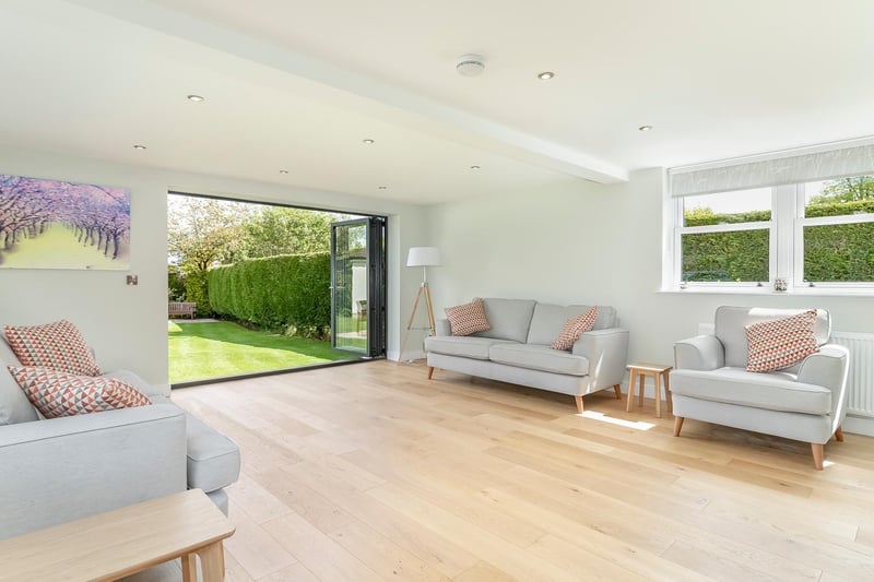 The dual aspect family room with wooden flooring and Bifold doors.