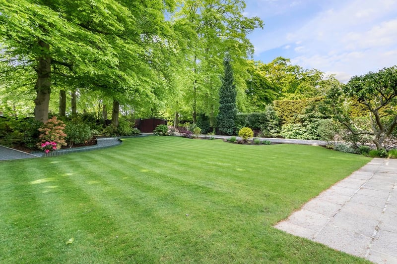 The front garden is mainly laid to lawn and bounded by shrubs and hedging.