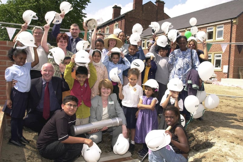 Youngsters from Leopold Primary School bury a time capsule at a housing development on Leopold Street.