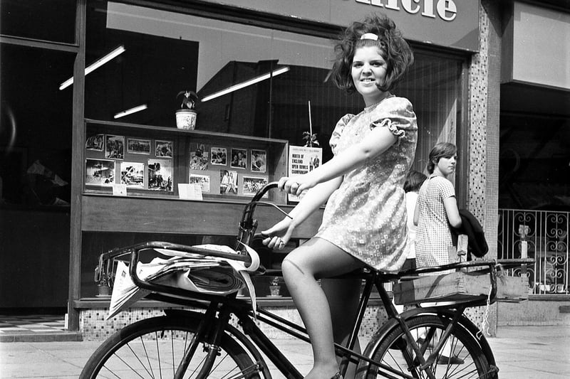 Wigan Evening Post and Chronicle tele-ads girl Jean Walsh helps out with delivery of the latest edition of Wigan's evening newpaper in 1970