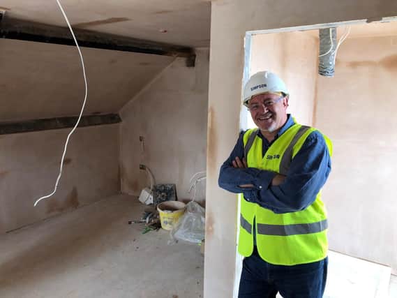 Harrogate Borough Council’s deputy leader and cabinet member for resources, enterprise and economic development, Coun Graham Swift, in one of the properties which is currently being regenerated.