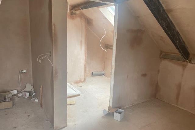 An en suite shower room in the master bedroom in one of the flats, which has now been plastered.