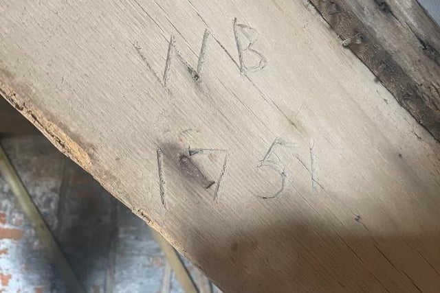 An original beam in the loft of one of the residencies, with a carving showing it is from the year 1751.