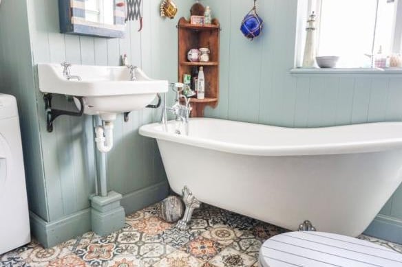 The modern bathroom has been decorated in relaxing eggshell tones, with a stunning tiled flooring. This space also benefits from a freestanding bath.