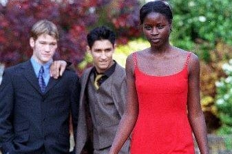 Students at Wakefield Girls High School wearing some of the fashions on show at their fashion show 1998, as Labo Ajulo 16 wears a red dress watched by Oliver Hughes 17, (left) and Amandeep Khela 17
