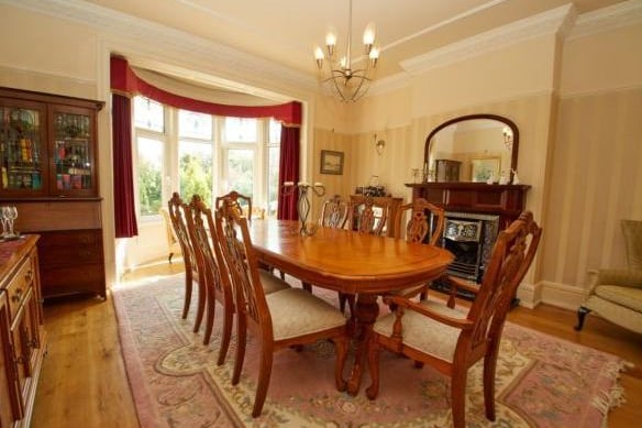 The formal dining room is also located off of the hallway and similar boasts a beautiful bay window. It has space for a large dining table, perfect for entertaining. The current owners also have a drinks cabinet for guests to enjoy - great for special occasions.