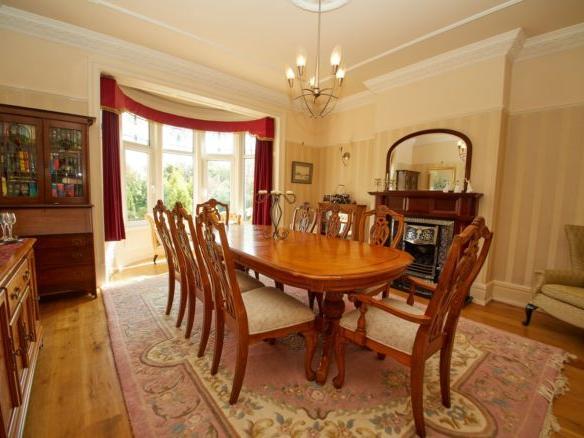 The formal dining room is also located off of the hallway and similar boasts a beautiful bay window. It has space for a large dining table, perfect for entertaining. The current owners also have a drinks cabinet for guests to enjoy - great for special occasions.