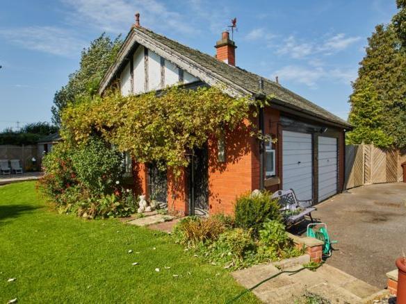 There is plenty of space for parking and storage as the property has a detached double garage.