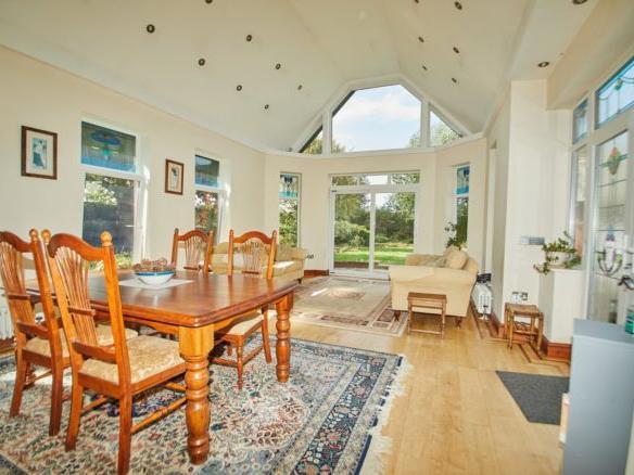 The family room is a modern extension that is filled with natural light and french doors leading out onto the garden.