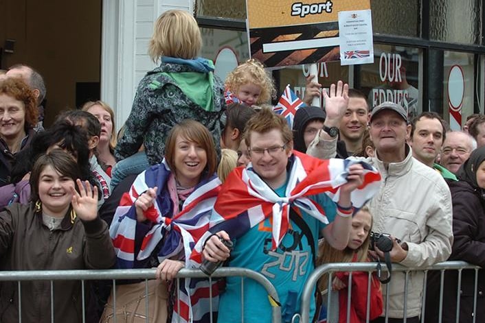 Crowds on Manchester Road see the Olympic Torch relay through Burnley town centre.