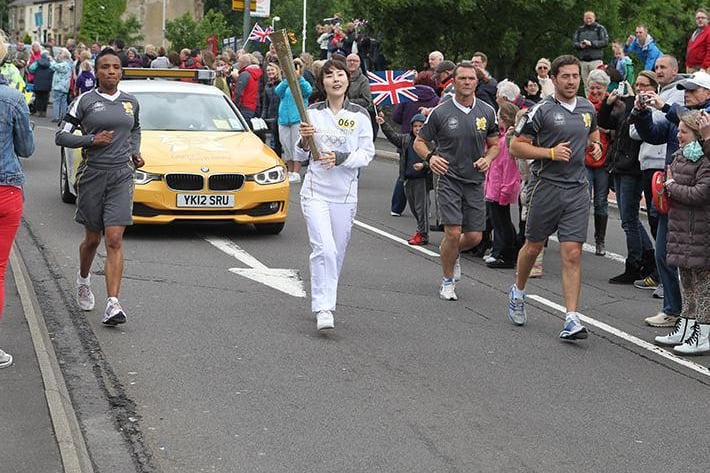 The Olympic Torch is carried through Burnley.