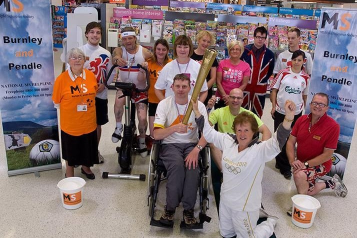 Wayne Moorhouse carried the Olympic Torch in Sainsbury's in Colne along with torchbearer Anne Ellwood during the fundraising event for the Burnley and Pendle MS Society.